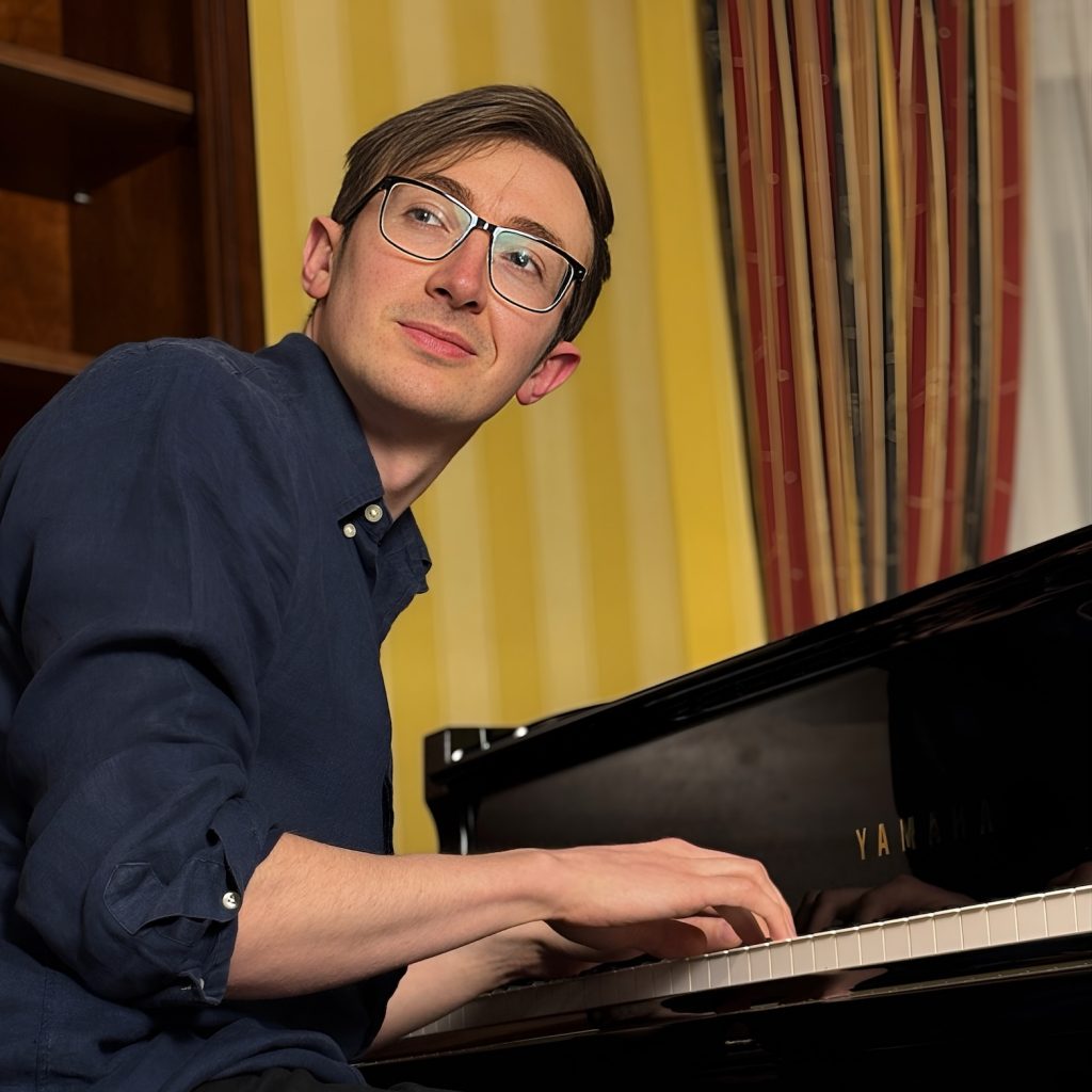 image of me sitting at a piano, turning back and looking behind